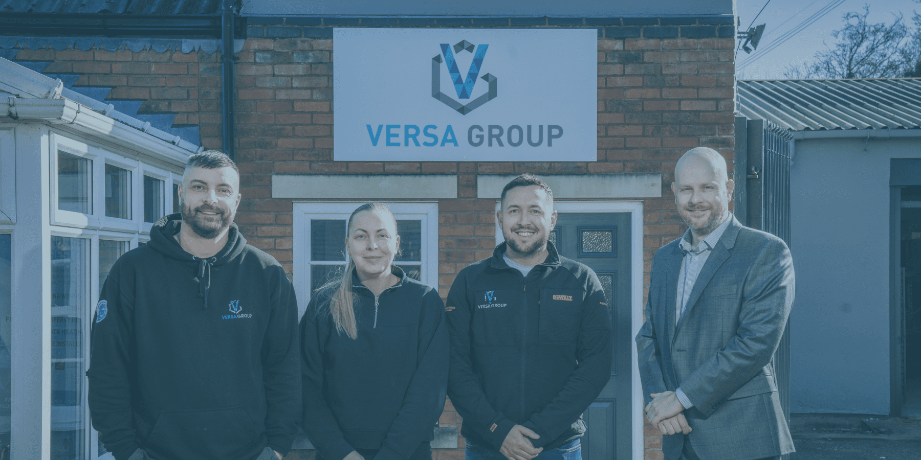 Versa Group staff and our Solicitor Andy Ward standing outside their new premises.