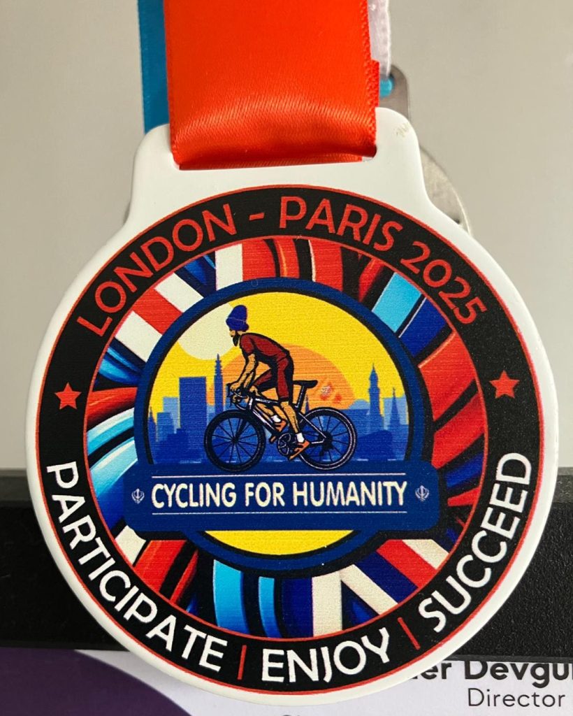 participation medal which is red, whie and blue. The charity logo is in the centre with the words participate, enjoy, succeed below.