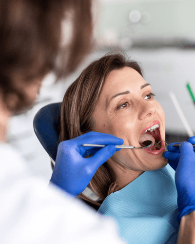 two people stand over a desk shaking hands