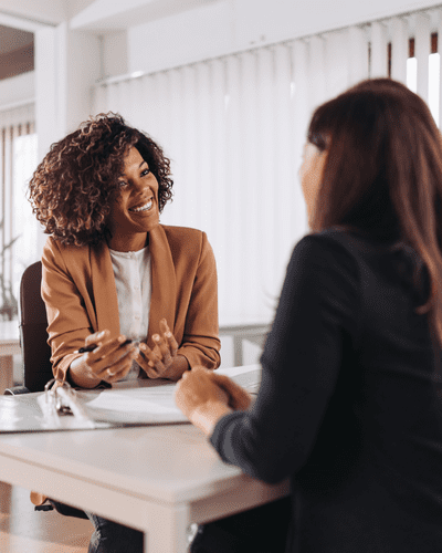 employment law advice - two people sit across a table looking down at documents