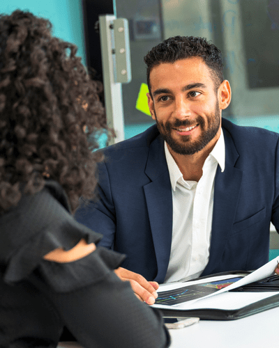 employment law advice - two people sit across a table looking down at documents